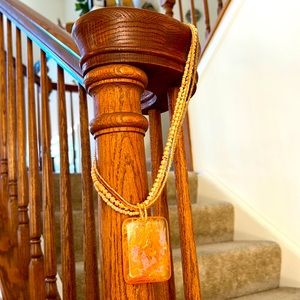 Necklace cute four bead strands 21” with plastic 2” pendant in soft peach color.